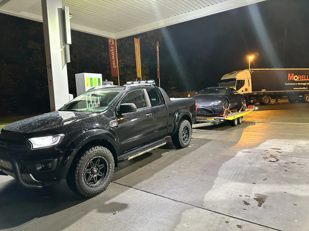 Ford Ranger towing a vehicle on a transport trailer