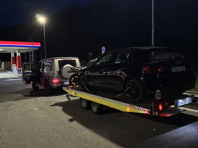 Mercedes G-Klasse mit beladenem Fahrzeuganhänger bei Nacht